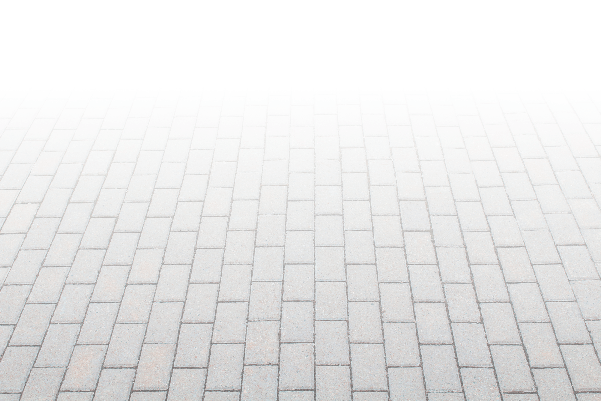 A uniform pattern of light gray rectangular paving stones, showing symmetry and simplicity, gradually fading into a bright white background.